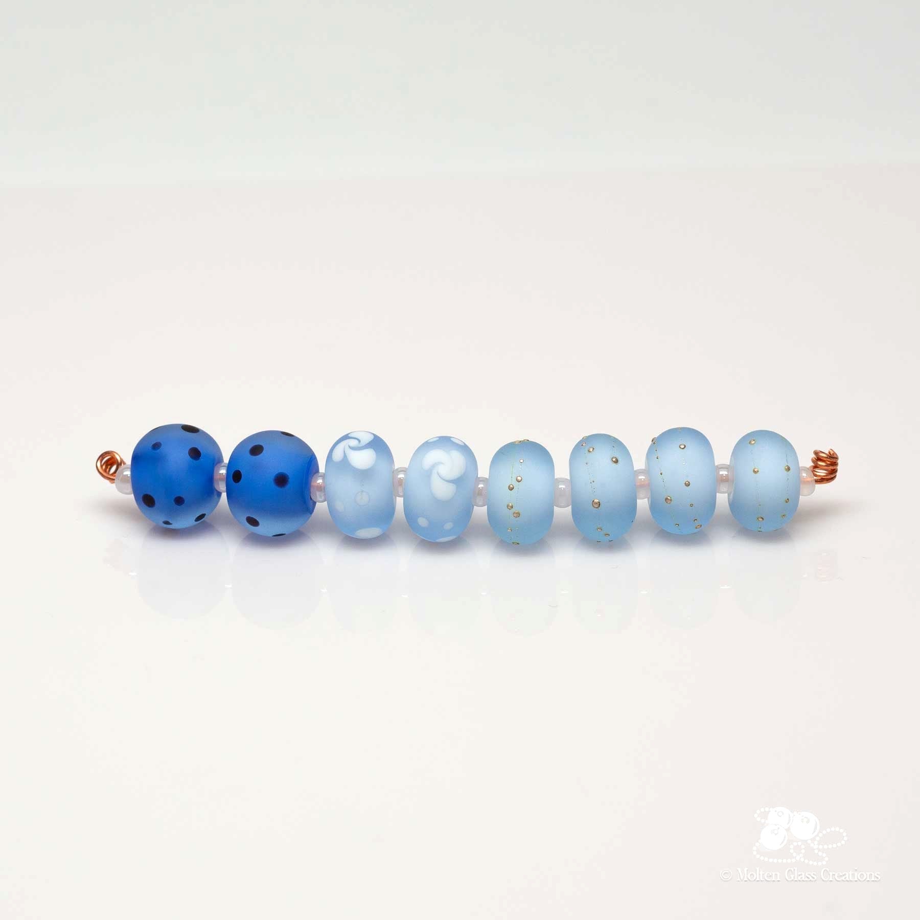 various shades of blue glass beads with a matt finish