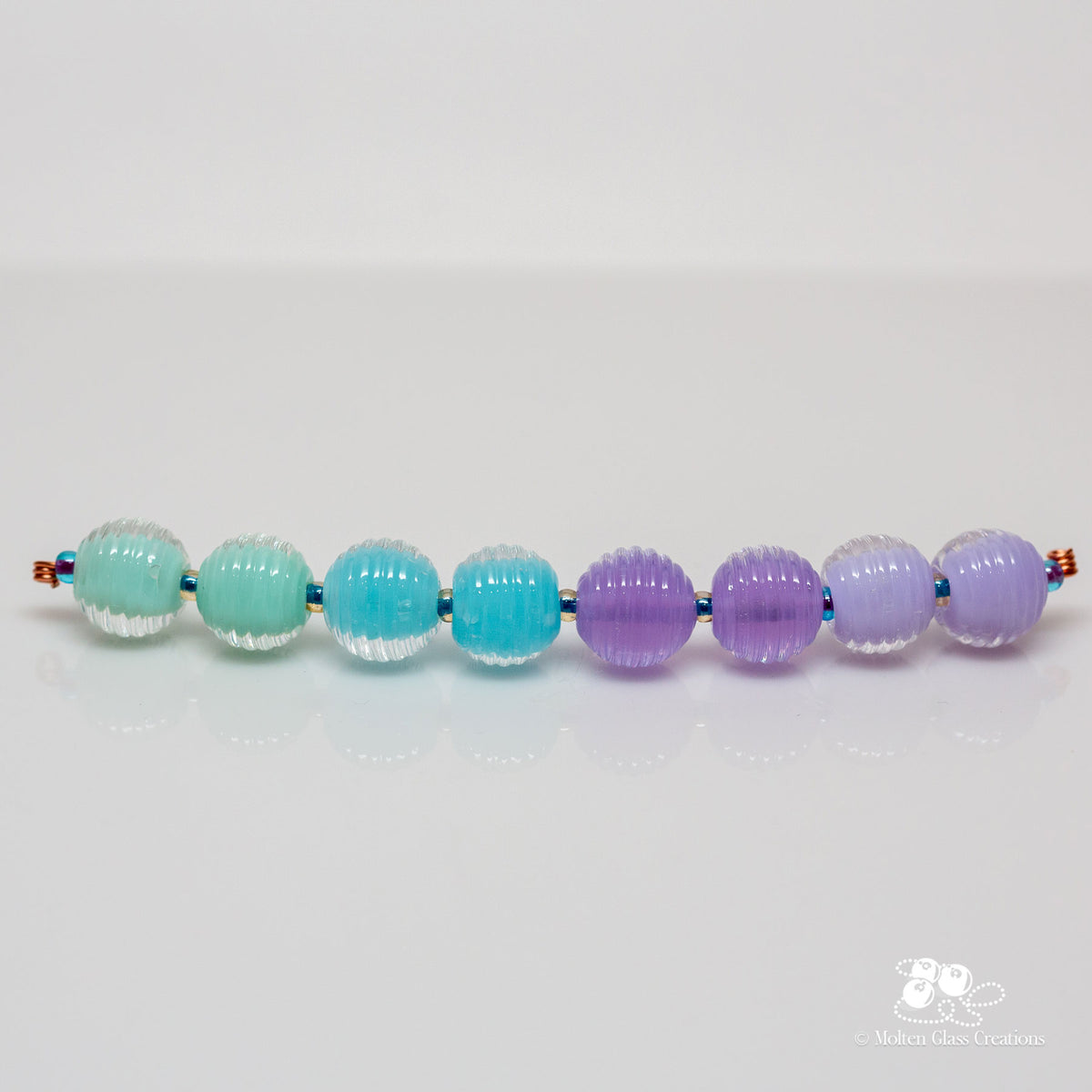 Set of colorful glass beads on a white background