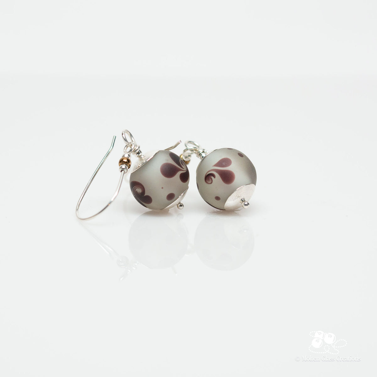 Pair of earrings with swirl design on a white background