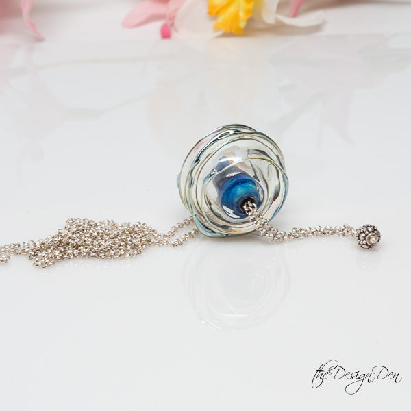 clear hollow bead with blue core and silver chain